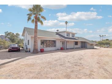 House exterior features a charming ranch design with a spacious front yard and mature landscaping at 4344 E Desert Crest Dr, Paradise Valley, AZ 85253