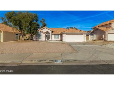 Single-story house with a two-car garage and desert landscaping at 6634 E Preston St, Mesa, AZ 85215