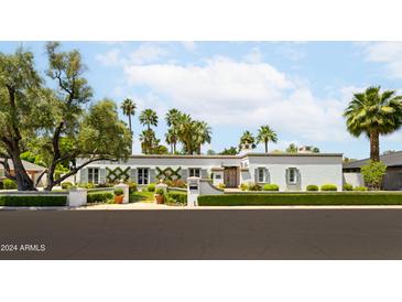 Stunning white house with manicured landscaping and a spacious front yard at 7528 N 10Th St, Phoenix, AZ 85020