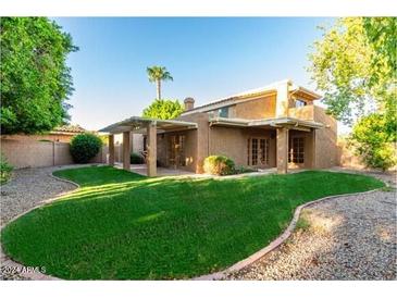 Large backyard with grassy lawn and covered patio area at 921 E Becker Ln, Phoenix, AZ 85020