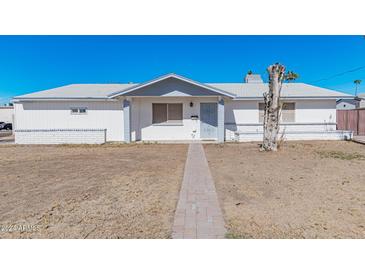 White brick ranch house with gray roof and walkway at 955 N Jay St, Chandler, AZ 85225