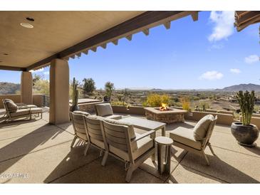 Covered patio with firepit and seating area, offering stunning mountain views at 9909 E Lookout Mountain Dr, Scottsdale, AZ 85262