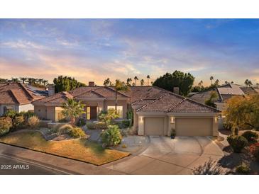 Beautiful desert home with tile roof, two-car garage, and mature landscaping at 11691 E Turquoise Ave, Scottsdale, AZ 85259