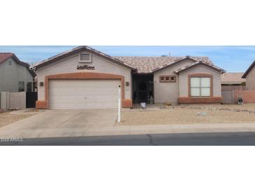 Charming single-story home featuring a well-maintained front yard and attached two-car garage at 1432 E Westchester Dr, Chandler, AZ 85249