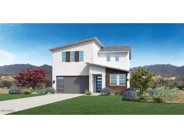 Two-story home with gray garage door and landscaped yard; mountain view in the background at 15426 S 182Nd Ave, Goodyear, AZ 85338