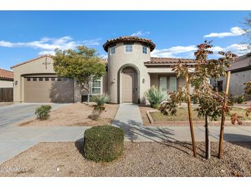 Single-story home with a unique architectural design and landscaping at 22174 E Creekside Dr, Queen Creek, AZ 85142