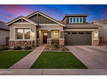 Charming single-Gathering home featuring stone accents, neutral paint, tidy landscaping and brick driveway at 22922 E Mayberry Rd, Queen Creek, AZ 85142