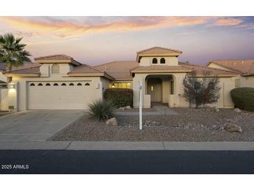 Single-story home with a neutral color palette and desert landscaping at 10048 E Emerald Dr, Sun Lakes, AZ 85248