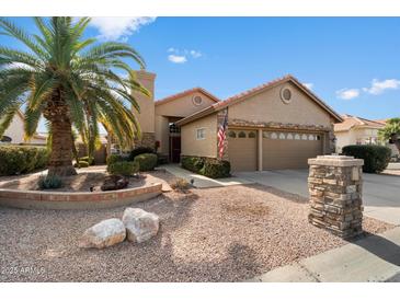 Single-story home with a two-car garage and desert landscaping at 10605 E Nacoma Dr, Sun Lakes, AZ 85248