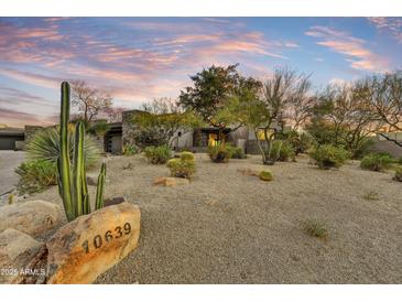 Stunning desert landscape home with modern architecture and a spacious front yard at 10639 E Fernwood Ln, Scottsdale, AZ 85262