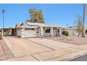 Updated single-story home with solar panels and a spacious driveway at 12451 N Cherry Hills E Dr, Sun City, AZ 85351