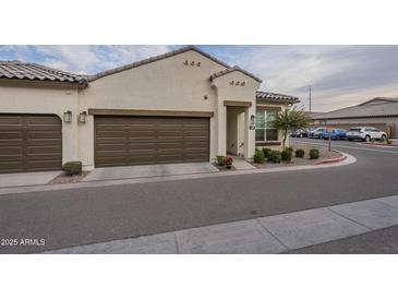 Tan two-car garage home with brown doors and landscaping at 1255 N Arizona Ave # 1109, Chandler, AZ 85225