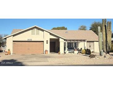 Tan one-story house with a two-car garage and desert landscaping at 1532 Leisure World --, Mesa, AZ 85206