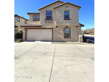 Two-story house with attached garage and driveway at 16425 W Latham St, Goodyear, AZ 85338