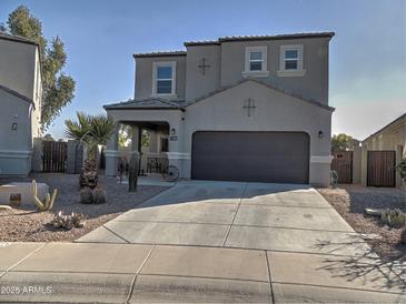 Two-story house with a two-car garage and desert landscaping at 19203 N Marbella Ave, Maricopa, AZ 85138