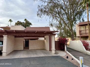 Spanish style home with covered parking and landscaped walkway at 2168 E Sanos Dr, Tempe, AZ 85281