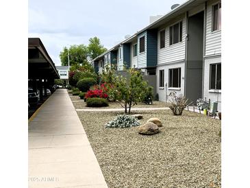 Building exterior with landscaped walkway and parking at 2606 W Berridge Ln # C208, Phoenix, AZ 85017