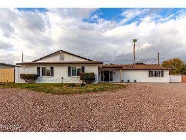 White single story house with a landscaped front yard at 2614 E Mountain View Rd, Phoenix, AZ 85028