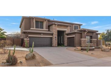 Two-story home with stone accents and a three-car garage at 2739 W Via Bona Fortuna Dr, Phoenix, AZ 85086