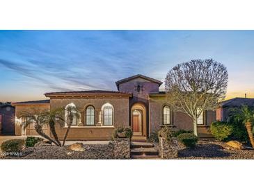 Beautiful desert home exterior at dusk with landscaped yard and two car garage at 29432 N 128Th Ln, Peoria, AZ 85383