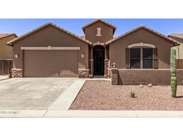 Single-story home with desert landscaping and a two-car garage at 35134 N Laredo Dr, San Tan Valley, AZ 85144