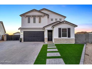 Two-story home with modern facade, dark garage door, and landscaped lawn at 37762 N Poplar Rd, San Tan Valley, AZ 85140