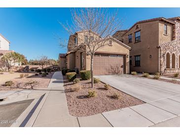 Two-story home with a brown garage door and landscaping at 4777 S Fulton Ranch Blvd # 1027, Chandler, AZ 85248