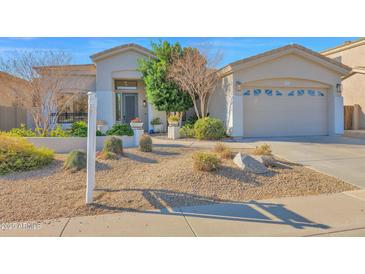 Single-story home with landscaped front yard and two-car garage at 4835 E Daley Ln, Phoenix, AZ 85054