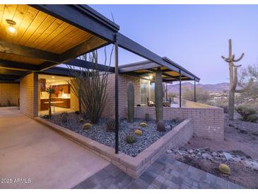 Mid-century modern home with desert landscaping and mountain views at 7724 E Long Rifle Rd, Carefree, AZ 85377