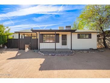 Charming single story home with a well-manicured front yard and spacious driveway at 8215 E 2Nd Ave, Mesa, AZ 85208