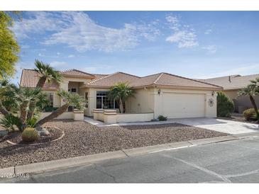 One-story house with tile roof, desert landscaping, and two-car garage at 9007 E Emerald Dr, Sun Lakes, AZ 85248