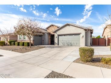 Beautiful single-Gathering home features a three-car garage, stone accents, and well-maintained landscaping at 21716 E Waverly Dr, Queen Creek, AZ 85142