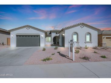 Single-story home with a two-car garage and desert landscaping at 3089 N 200Th Ave, Buckeye, AZ 85396