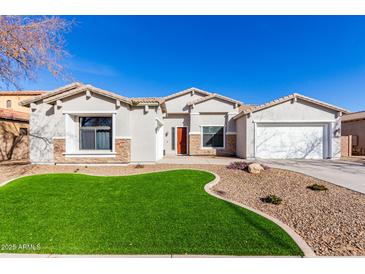 One-story home with a landscaped yard, two-car garage, and neutral exterior at 3332 E Powell Pl, Chandler, AZ 85249