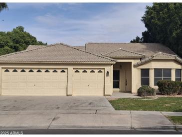 Single-story house with a three-car garage and landscaped front yard at 4841 S Vista Pl, Chandler, AZ 85248