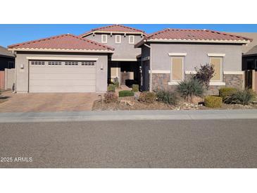 Front view of a two-story house with a three-car garage at 6616 W Side Canyon Trl, Phoenix, AZ 85083