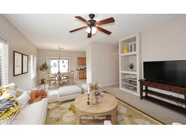 Open-concept living room with view of dining area and kitchen at 6657 E Regina St, Mesa, AZ 85215