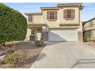 Two-story house with a two-car garage and landscaped front yard at 18164 W Smokey Dr, Surprise, AZ 85388