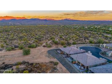 Aerial view of homes and desert landscape with mountain views at 18324 E Spring Valley Ct, Rio Verde, AZ 85263