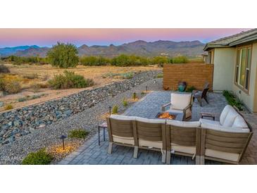 Covered patio with seating area, fire pit, and mountain views at 18324 E Spring Valley Ct, Rio Verde, AZ 85263
