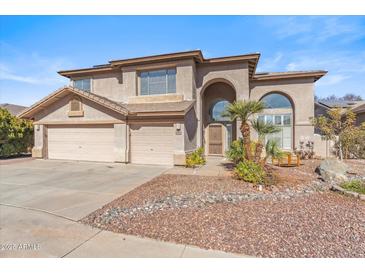 Two-story house with a three-car garage and landscaped front yard at 2380 W Megan St, Chandler, AZ 85224