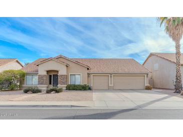 Charming single-story home featuring a three car garage and a xeriscaped front yard for low maintenance at 9441 E Juanita Ave, Mesa, AZ 85209