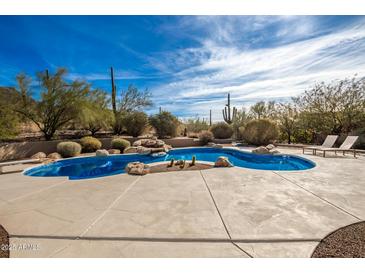 Inviting freeform pool with a large patio and mountain views at 36039 N 58Th St, Cave Creek, AZ 85331