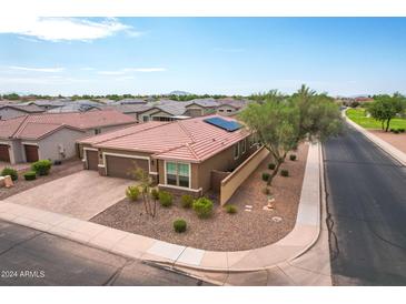 Single-story home with solar panels, two-car garage, and landscaped yard at 809 W Palo Verde Dr, Casa Grande, AZ 85122