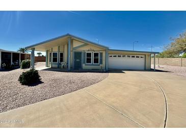 Single-story home with attached garage and landscaped yard at 8500 E Southern Ave # 405, Mesa, AZ 85209