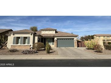 Charming single-story home with well-manicured desert landscaping and a two car garage at 13602 W Cheery Lynn Rd, Avondale, AZ 85392
