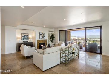 Spacious living room with fireplace and access to balcony at 7181 E Camelback Rd # 904, Scottsdale, AZ 85251