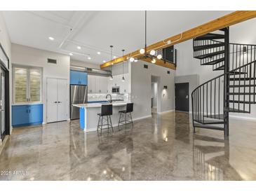 Modern kitchen with blue cabinets, island, and open floor plan at 914 E Osborn Rd # 208, Phoenix, AZ 85014