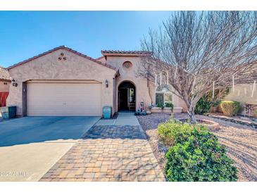 Charming single-story home featuring a well-maintained front yard and a two-car garage at 10851 E Sonrisa Ave, Mesa, AZ 85212
