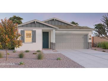 One-story home with gray siding, two-car garage, and landscaped front yard at 12539 W Parkway Ln, Avondale, AZ 85323
